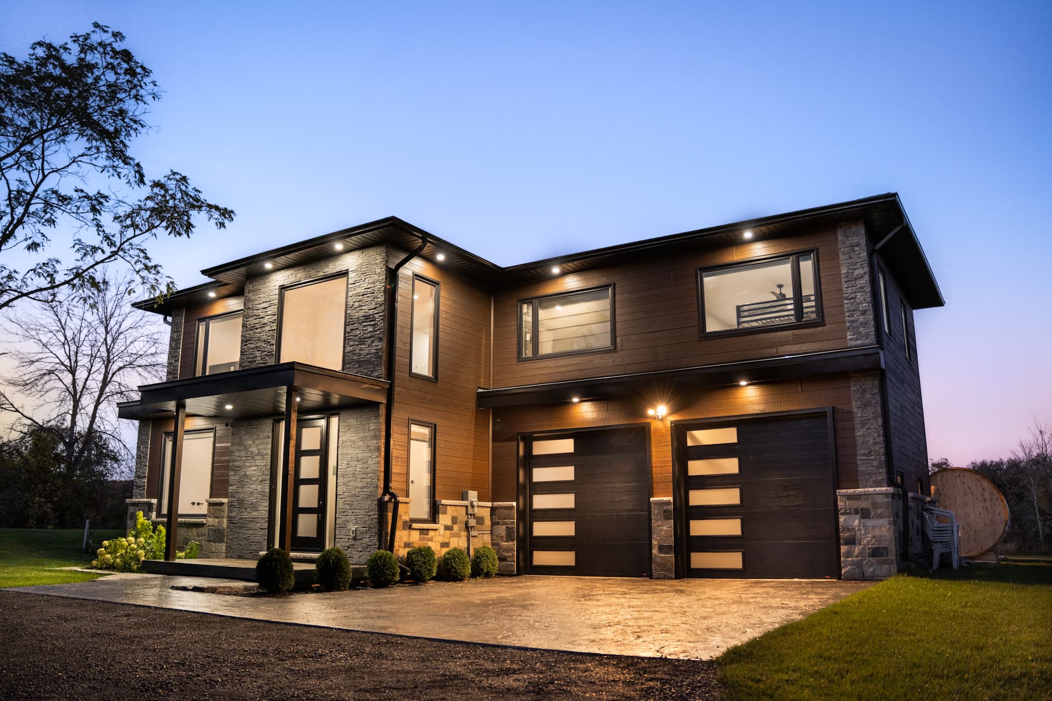 Modern two-storey home at dusk, managed by TNG